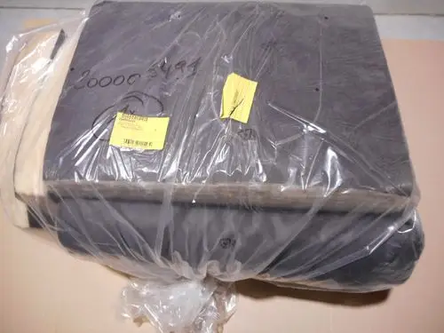 Verpackte Isolierung mit Folie um einen Remeha Kesselkörper, auf einer neutralen Unterlage, mit gelben Etiketten zur Kennzeichnung.